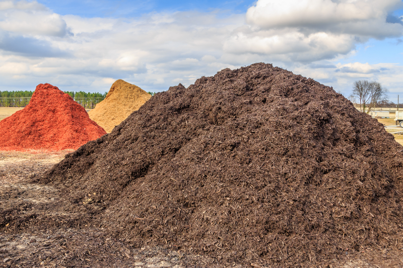 Large Piles of Mulch in Black Red and Brown